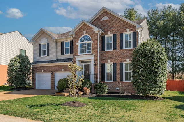 view of front facade featuring driveway, a front yard, and brick siding