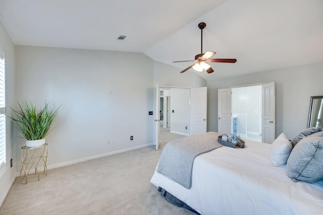 bedroom featuring lofted ceiling, light colored carpet, visible vents, a ceiling fan, and baseboards