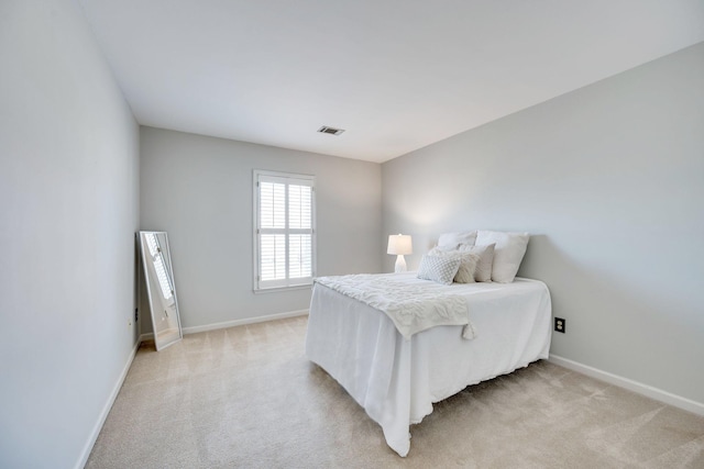 bedroom featuring light carpet, baseboards, and visible vents