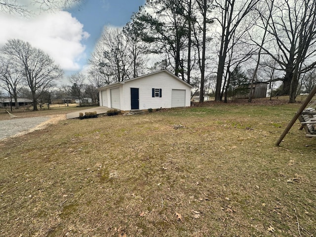 view of yard with an outbuilding and a detached garage