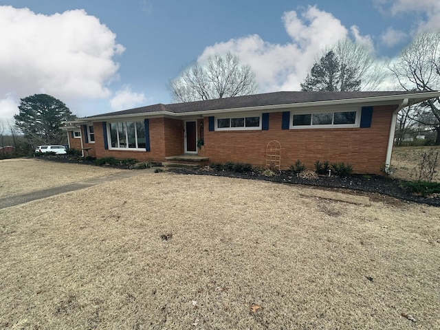 ranch-style house featuring brick siding