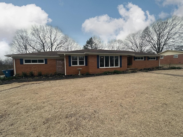 ranch-style house featuring brick siding