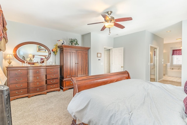 bedroom featuring light carpet, a ceiling fan, and connected bathroom