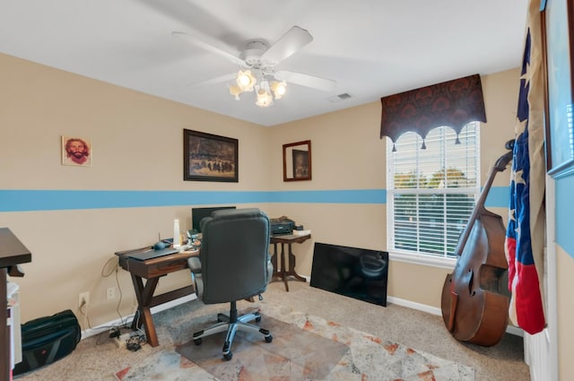 office featuring ceiling fan, carpet flooring, visible vents, and baseboards