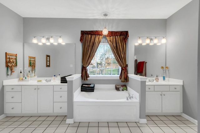 bathroom featuring baseboards, two vanities, tile patterned floors, a garden tub, and a sink