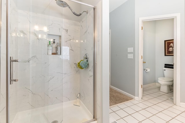 bathroom featuring baseboards, toilet, a marble finish shower, and tile patterned floors