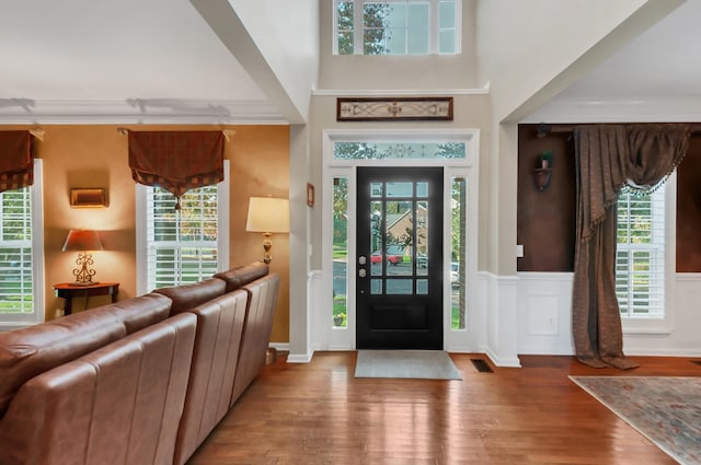 entryway featuring wood finished floors, visible vents, and a healthy amount of sunlight