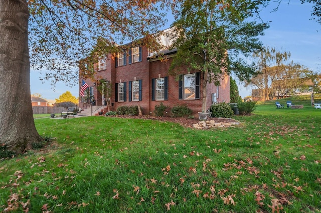 view of home's exterior featuring a lawn and brick siding