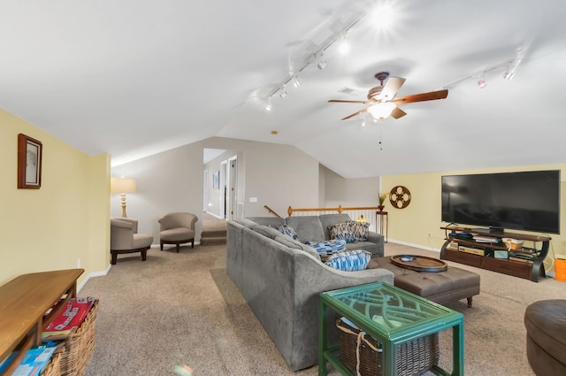 living area with lofted ceiling, ceiling fan, carpet floors, baseboards, and track lighting