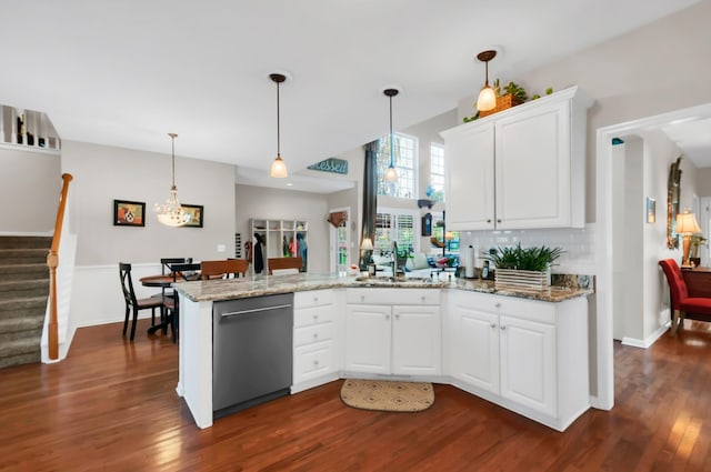 kitchen with a peninsula, a sink, white cabinets, stainless steel dishwasher, and dark wood-style floors