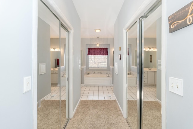 hallway with carpet and tile patterned floors