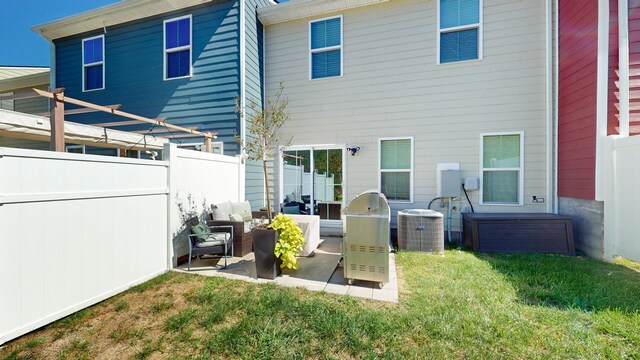 back of property featuring fence, a patio, and central air condition unit