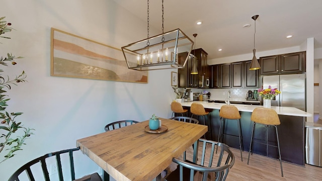 dining space with recessed lighting and light wood-style floors