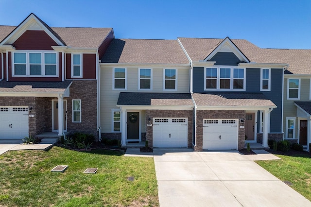 view of property with a garage, driveway, roof with shingles, and a front yard