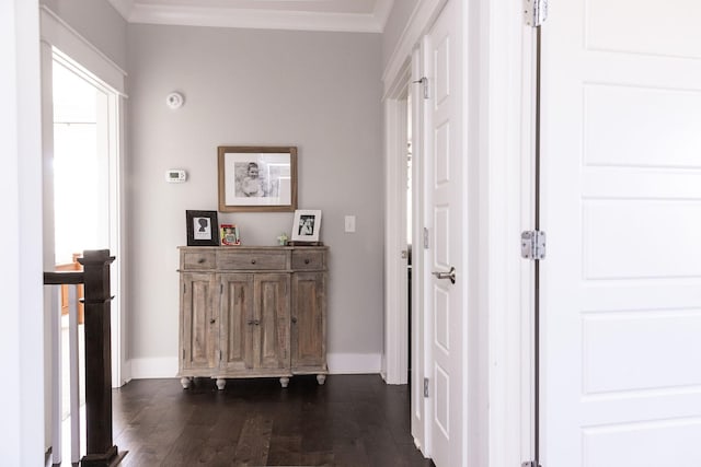 corridor with baseboards, dark wood finished floors, and crown molding