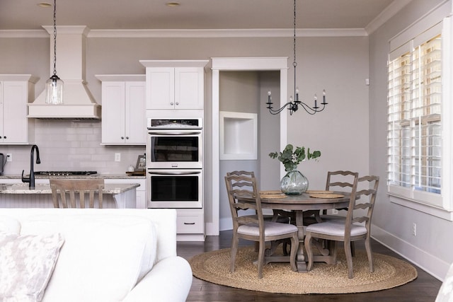 kitchen with stainless steel appliances, a healthy amount of sunlight, and crown molding