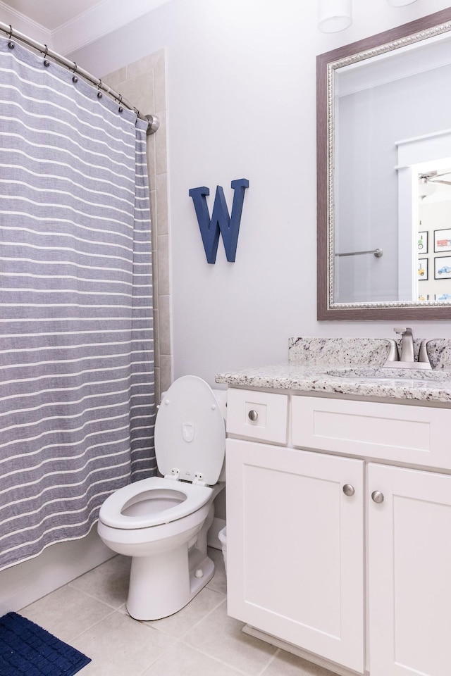 bathroom featuring toilet, vanity, a shower with shower curtain, and tile patterned floors