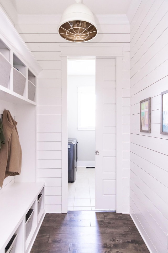 mudroom featuring wood walls and dark wood finished floors