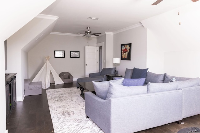 living area featuring ceiling fan, dark wood-style floors, visible vents, and crown molding