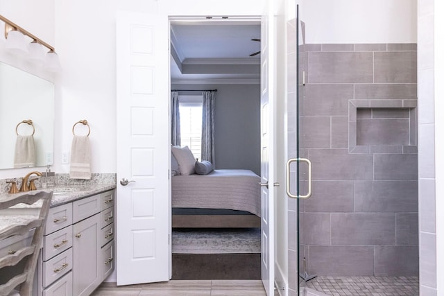 bathroom with wood finished floors, vanity, a stall shower, ensuite bath, and crown molding