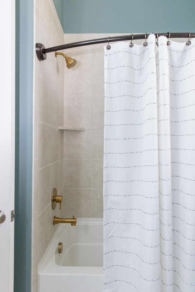 bathroom with shower / bath combination with curtain