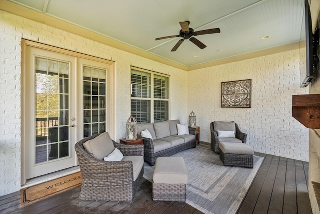 deck with an outdoor living space, a ceiling fan, and french doors