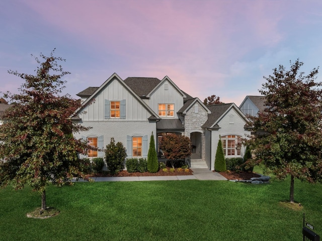 view of front of property featuring a front lawn and board and batten siding