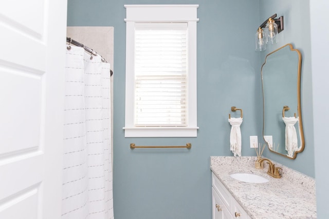 bathroom with a shower with shower curtain and vanity