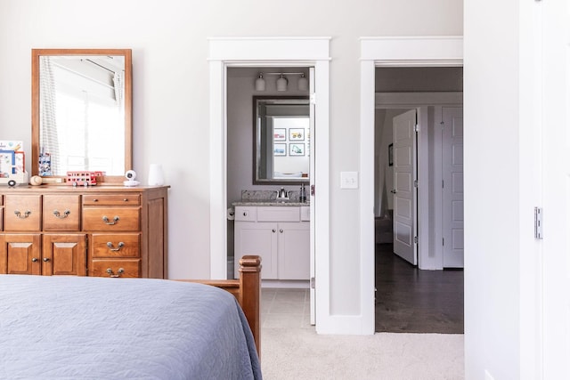 bedroom featuring a sink, carpet floors, and connected bathroom