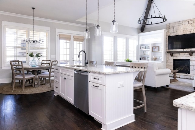 kitchen with dark wood-style floors, white cabinetry, a sink, and stainless steel dishwasher