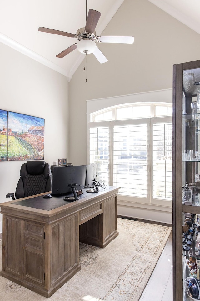 office area with a ceiling fan, vaulted ceiling, and crown molding