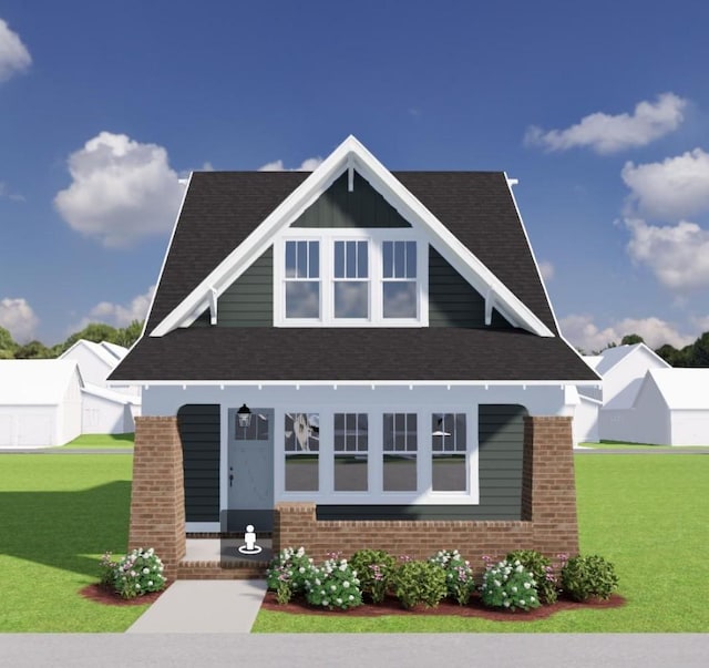 view of front of house featuring a front yard and brick siding