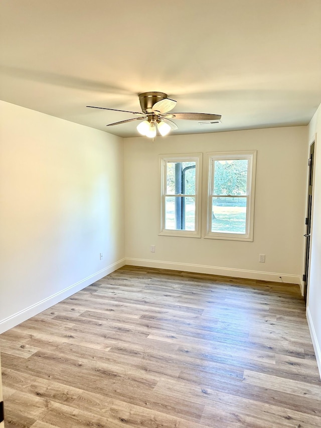 unfurnished room featuring ceiling fan, baseboards, and wood finished floors