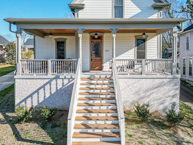 view of front of home with a porch and stairway