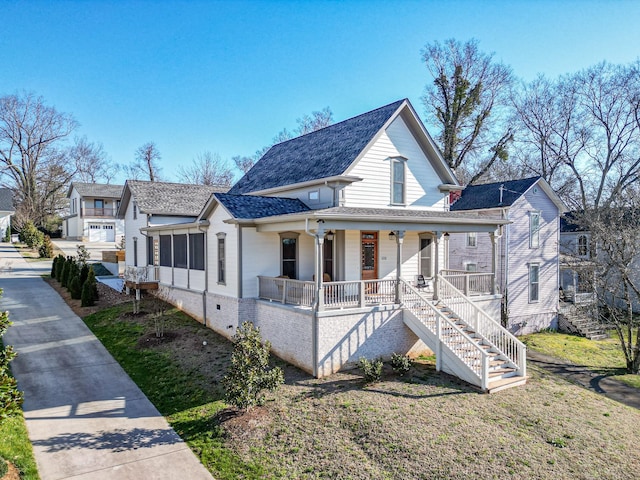 view of front of home featuring crawl space, roof with shingles, covered porch, and stairs