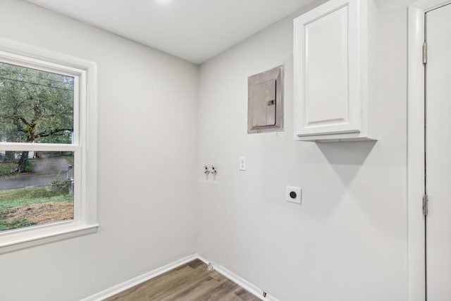 laundry room featuring a healthy amount of sunlight, cabinet space, electric panel, and electric dryer hookup