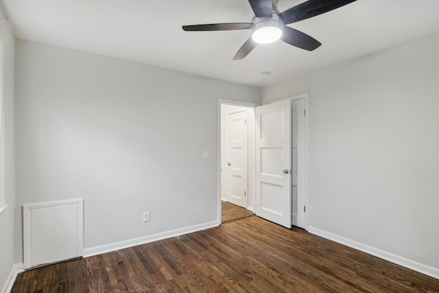 unfurnished room featuring a ceiling fan, baseboards, and wood finished floors