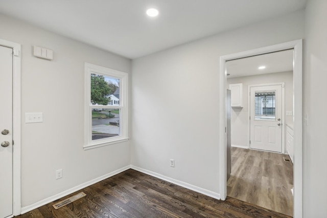 spare room featuring baseboards, visible vents, wood finished floors, and recessed lighting