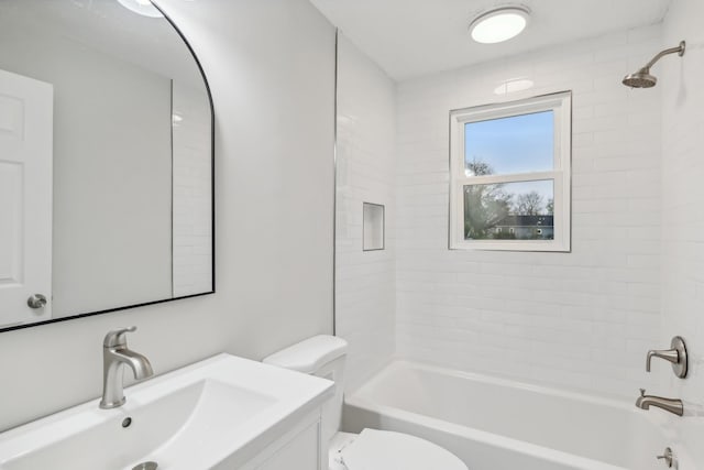 bathroom with bathtub / shower combination, vanity, and toilet