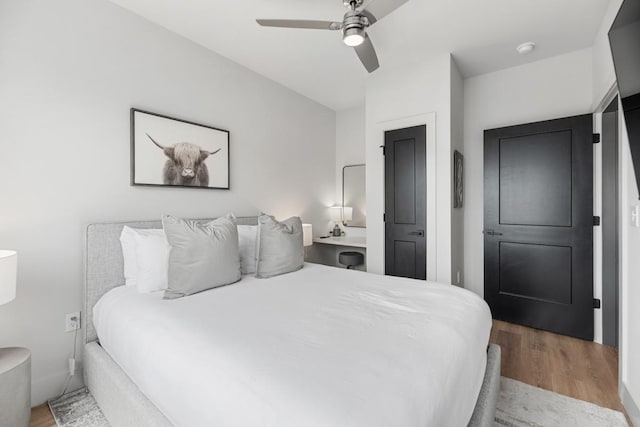 bedroom with a ceiling fan and wood finished floors