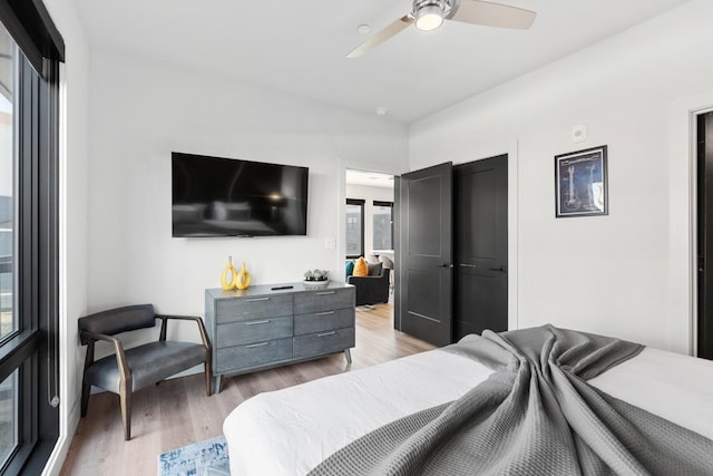 bedroom with light wood-type flooring and ceiling fan