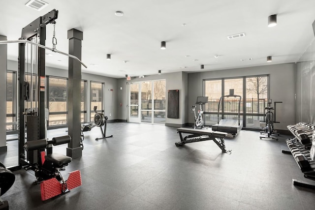 gym with baseboards and visible vents