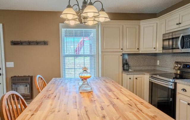 kitchen featuring heating unit, stainless steel appliances, and wooden counters