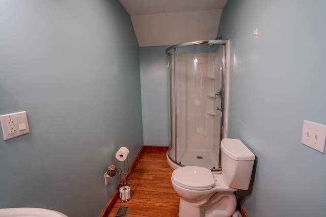 full bath with toilet, wood finished floors, visible vents, baseboards, and a shower stall