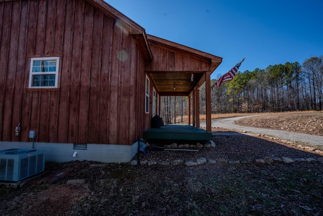 view of home's exterior with crawl space and central air condition unit