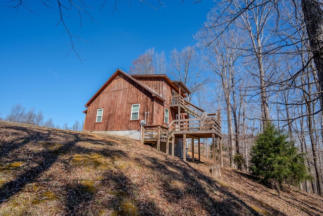 view of home's exterior featuring a deck and stairs