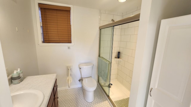 full bathroom featuring toilet, vanity, baseboards, tile patterned floors, and a stall shower