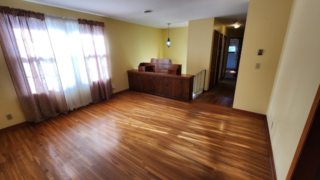 interior space featuring visible vents, baseboards, and wood finished floors