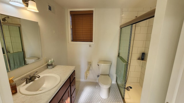 bathroom featuring visible vents, baseboards, toilet, vanity, and a shower stall