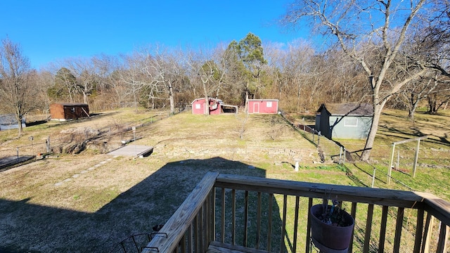 view of yard featuring a storage shed and an outbuilding